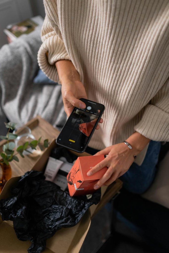 a creator photographing a product as she unboxes for a gifted brand collaboration
